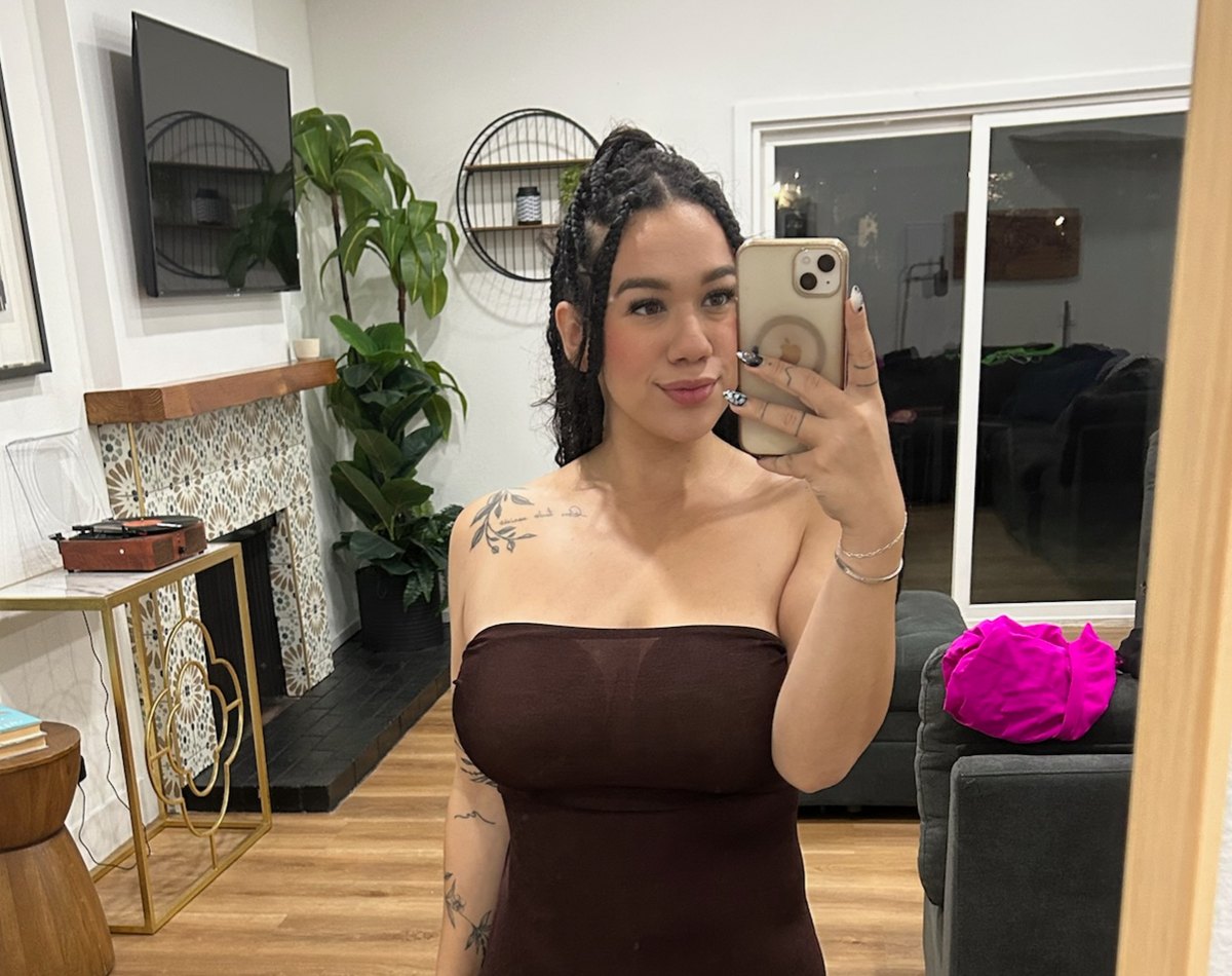 Britt XOXO taking a mirror photo in a brown dress